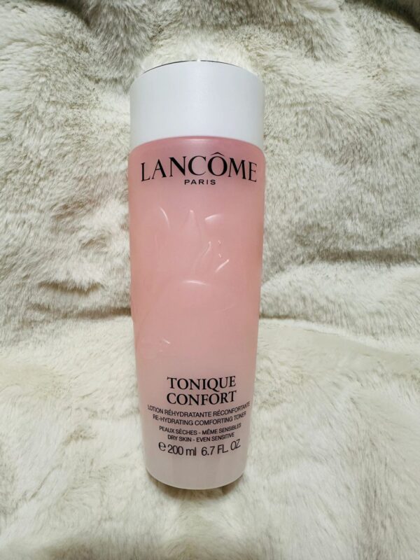 Pink Lancôme toner bottle on soft fabric