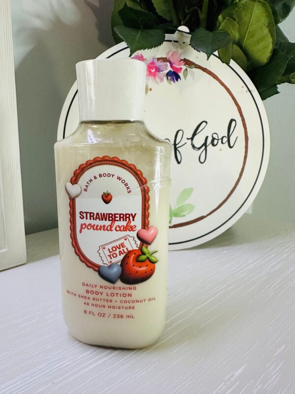 Strawberry body lotion on white table