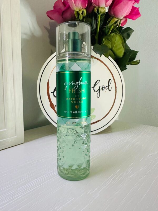 Perfume bottle with pink roses background
