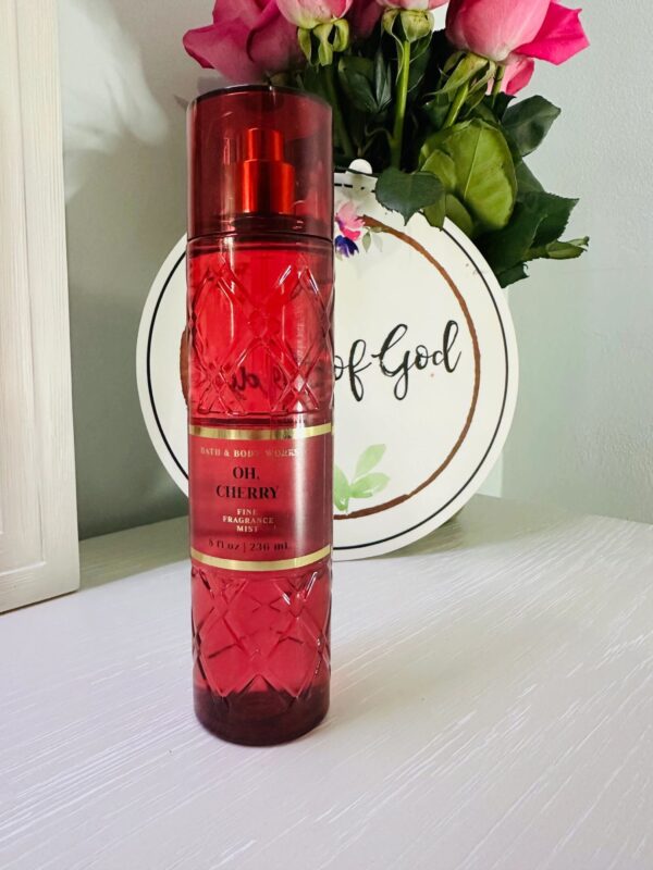Red perfume bottle with floral background