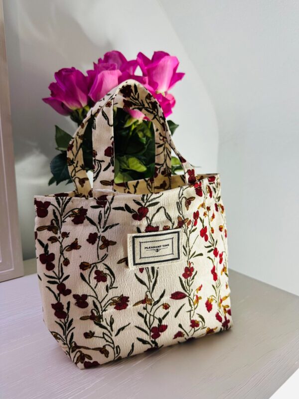 Decorative bag beside vibrant roses